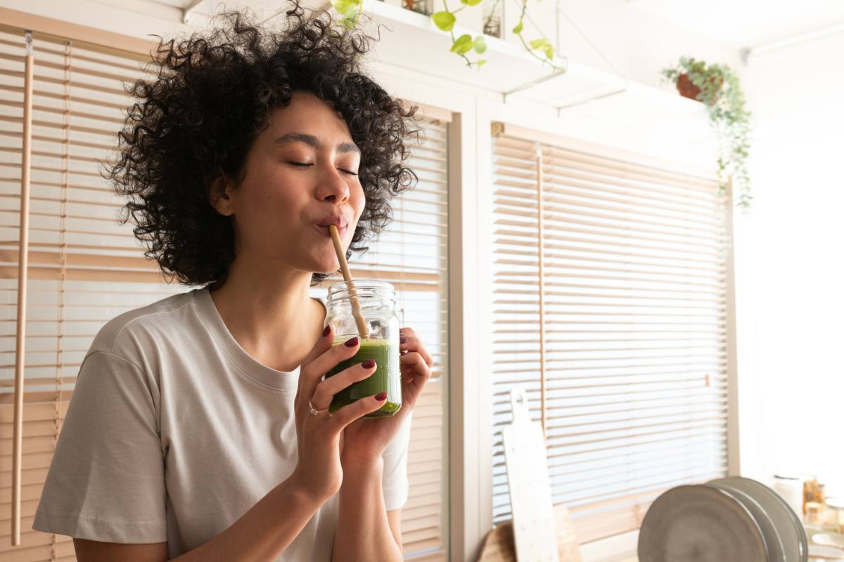 Woman sips on healthy smoothie