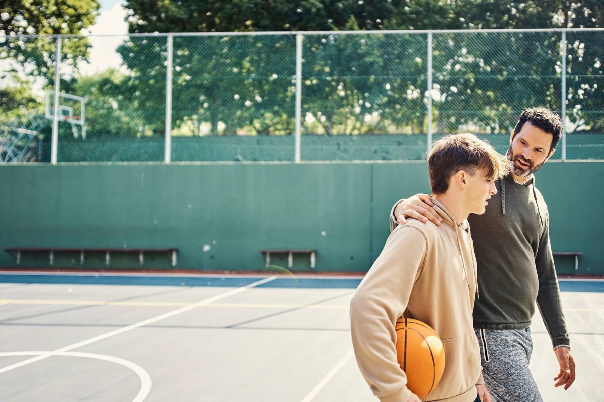 Father and Son spending quality time together playing basketball