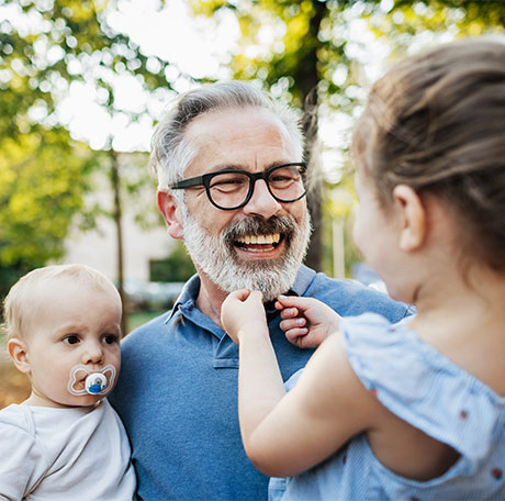 Smiling father with young children