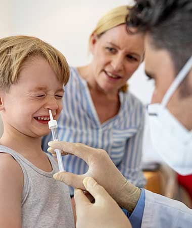 A child receiving nasal spray as an alternative to adenoidectomy