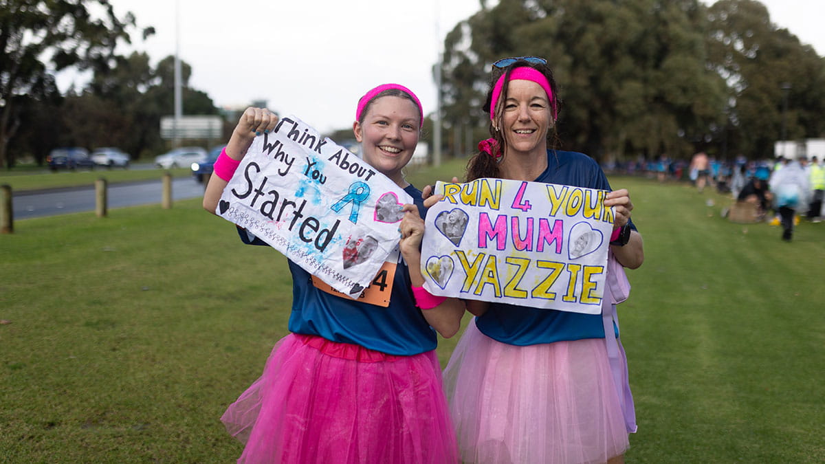Run for a reason - women holding up signs on the sideline
