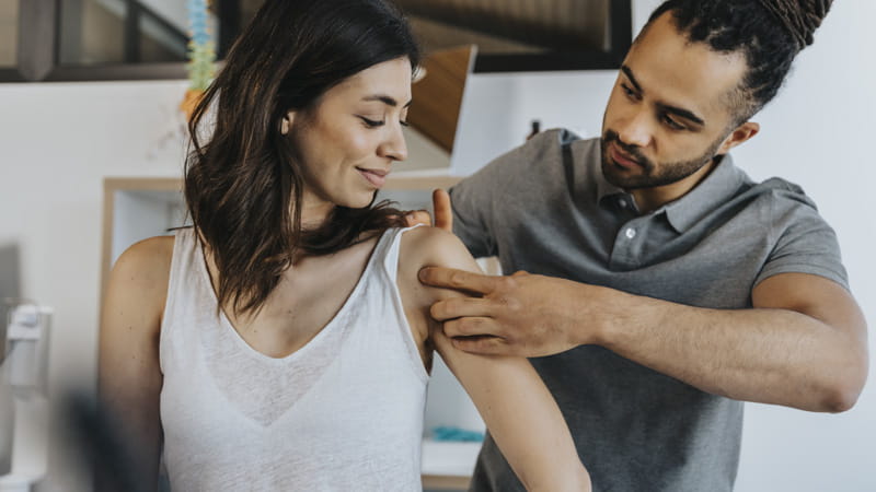 Physio helping patient