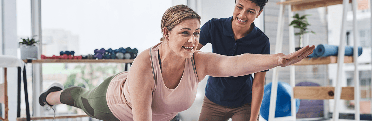 Woman stretching with her physiotherapist