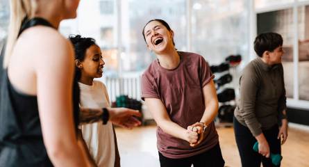 Young women laughing during a group gym class