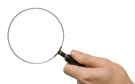 Hand holding a magnifying glass